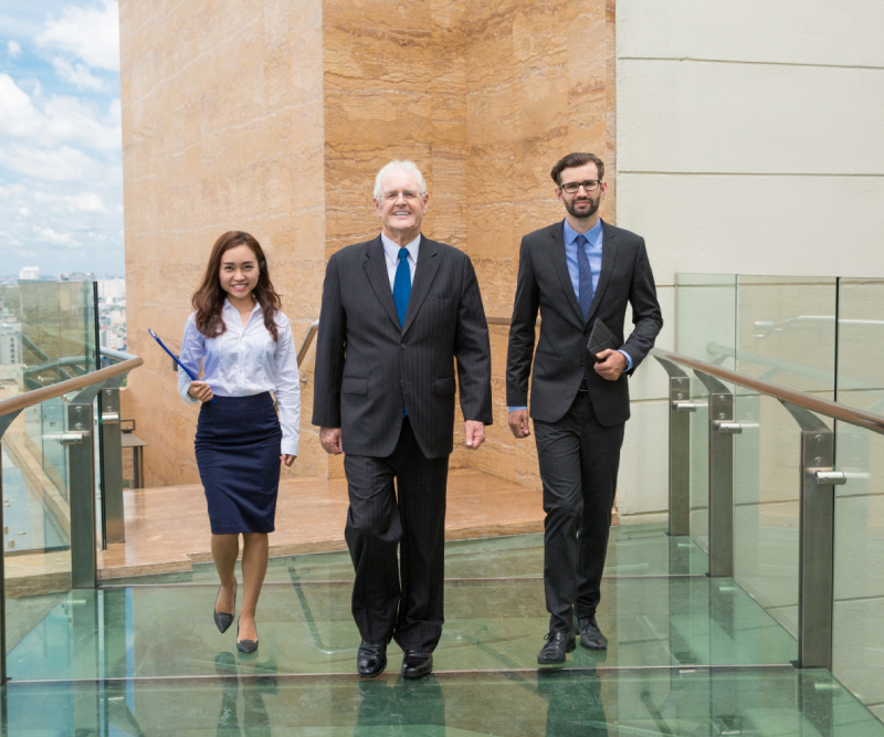Business people walking on a glass walkway