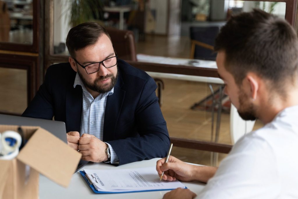 Nevada business contract attorney reviewing a commercial agreement with clients before signing.