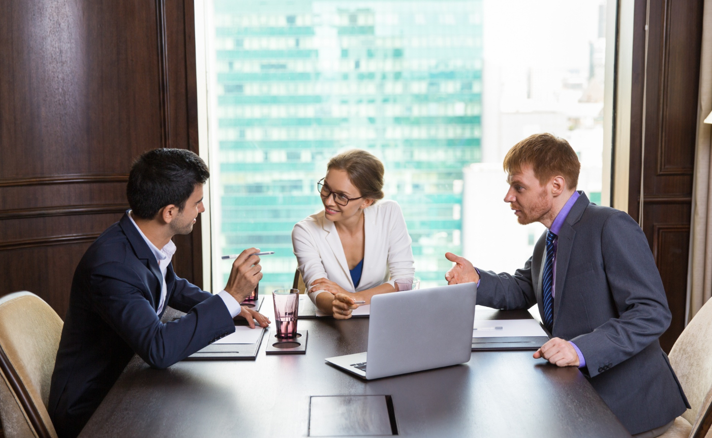 Business litigation attorney meeting with company owners to discuss commercial disputes, legal strategy, and risk assessment.