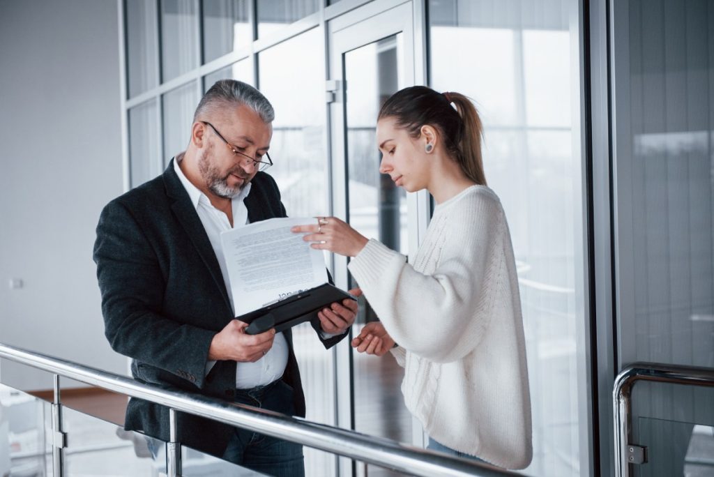 Business attorney reviewing acquisition documents with a buyer before purchasing a Nevada business.
