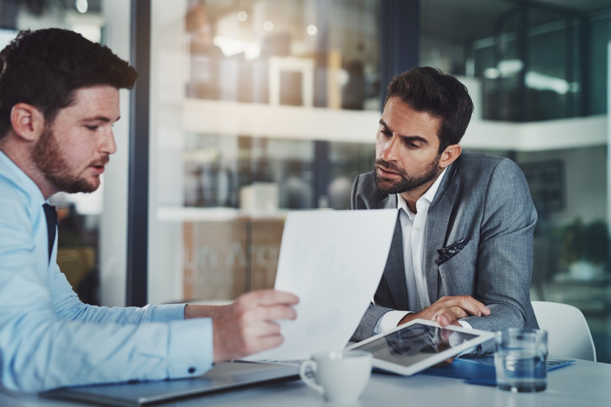 Business owner reviewing dissolution documents with a Nevada business lawyer before closing a company.