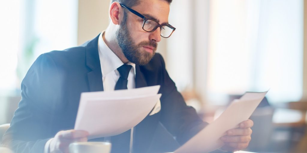 Business attorney reviewing trademark registration and brand protection documents for a Nevada company.