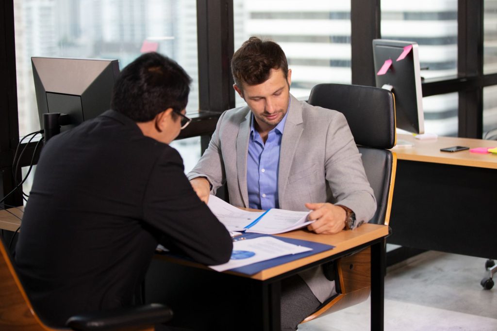 Nevada business owner reviewing LLC formation documents with an attorney