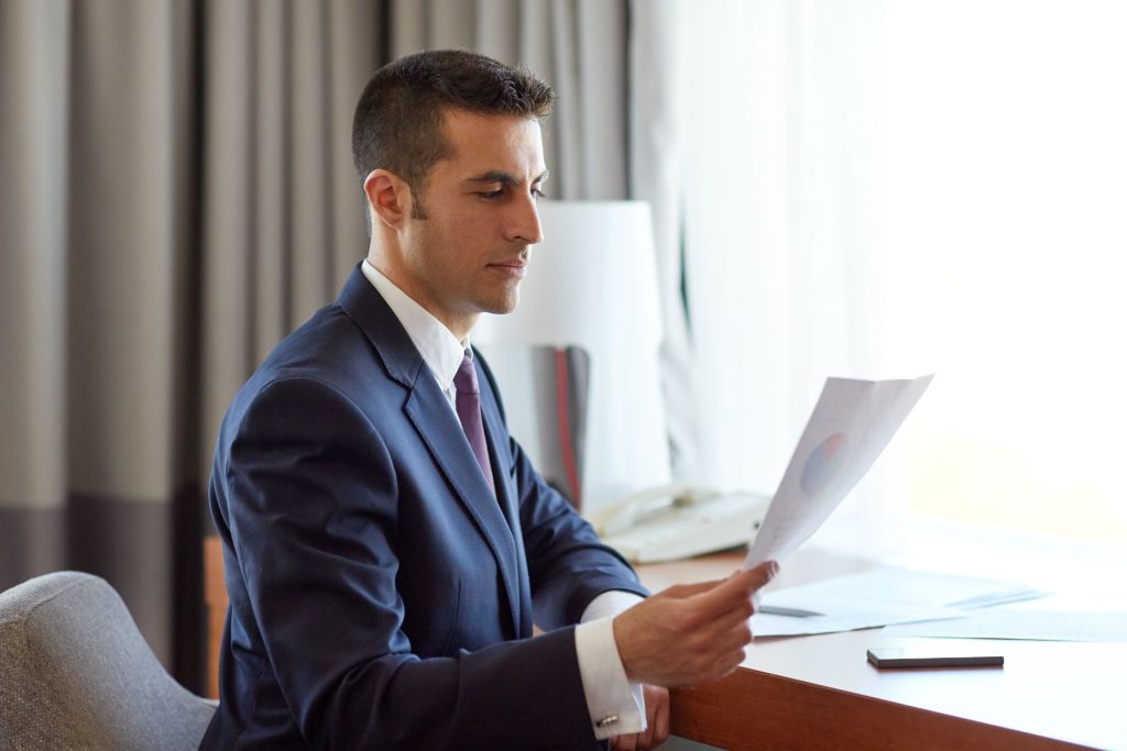 Business attorneys reviewing litigation and settlement options