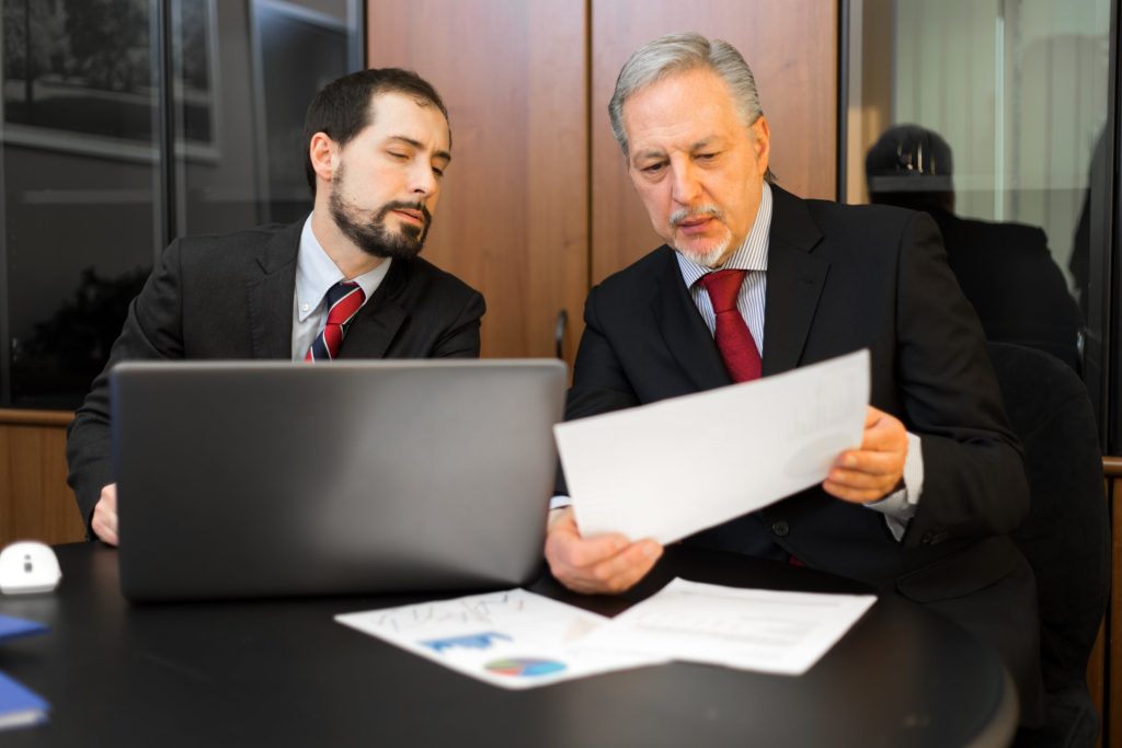 Attorney reviewing business valuation documents for a Nevada acquisition