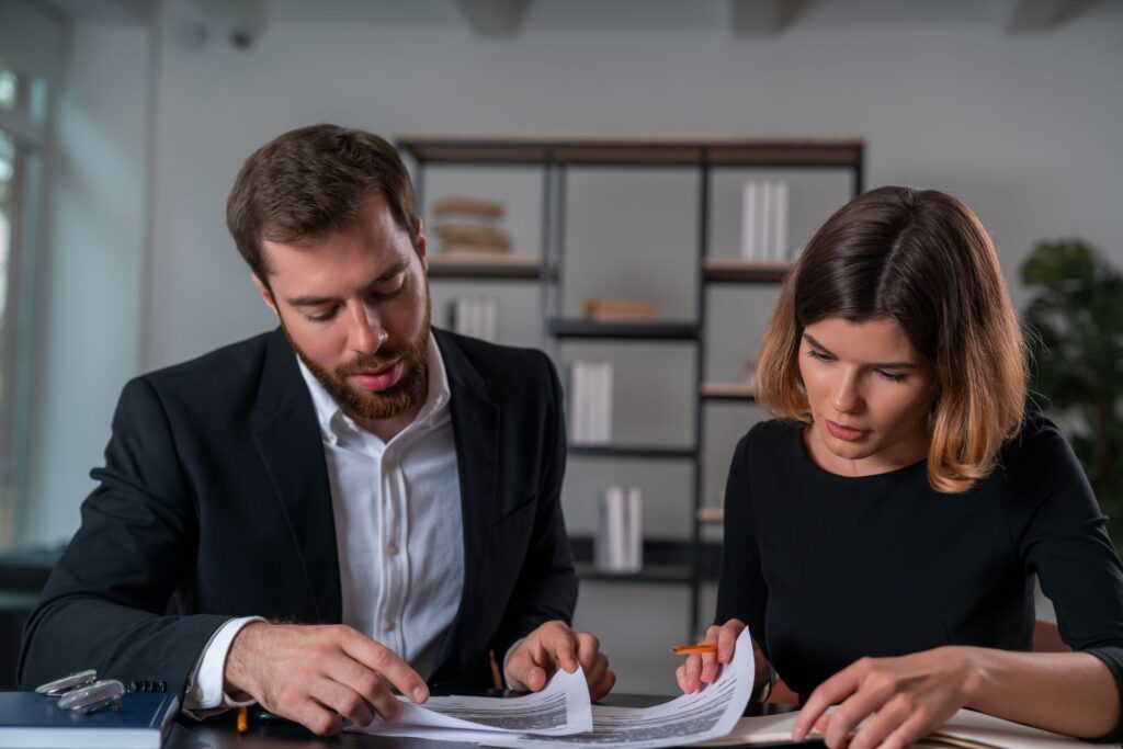 Reno small business owner reviewing contracts and compliance documents with an attorney