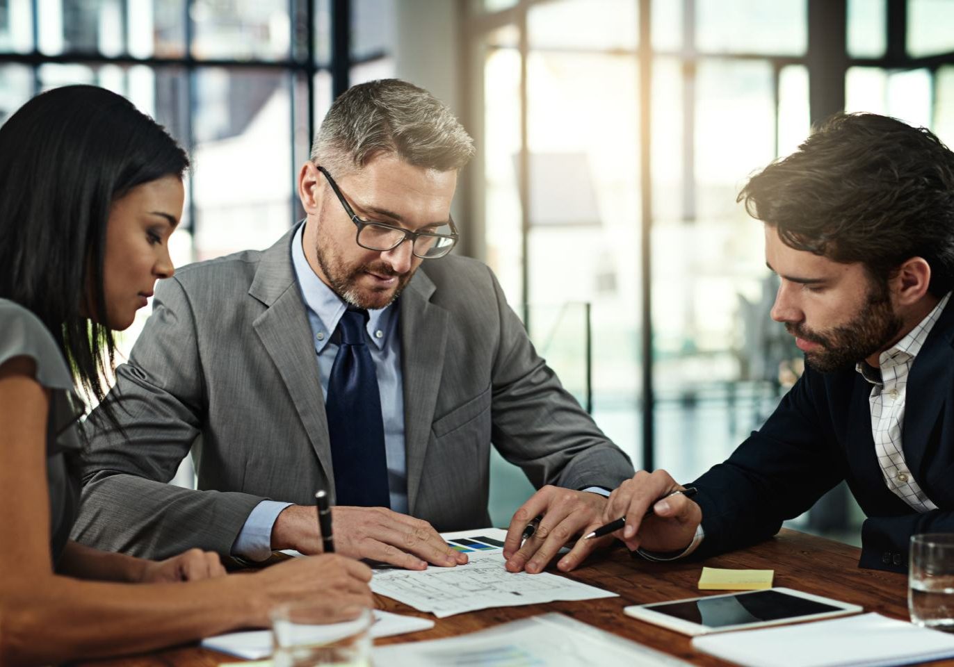 Nevada business partners reviewing a buy-sell agreement with a business attorney.