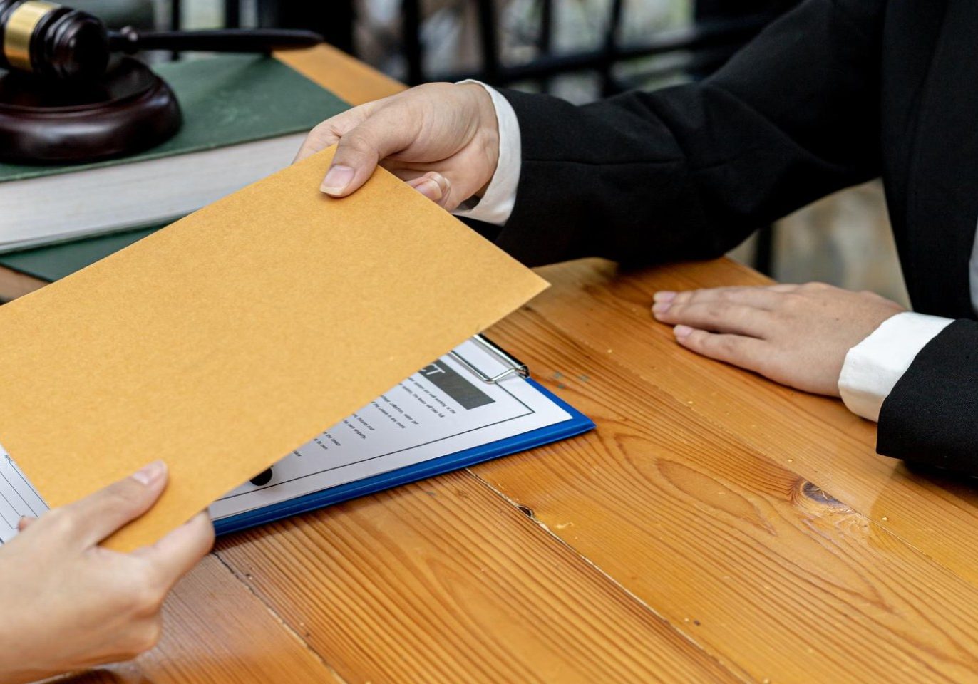 Nevada business owner reviewing unpaid invoices with a business attorney.